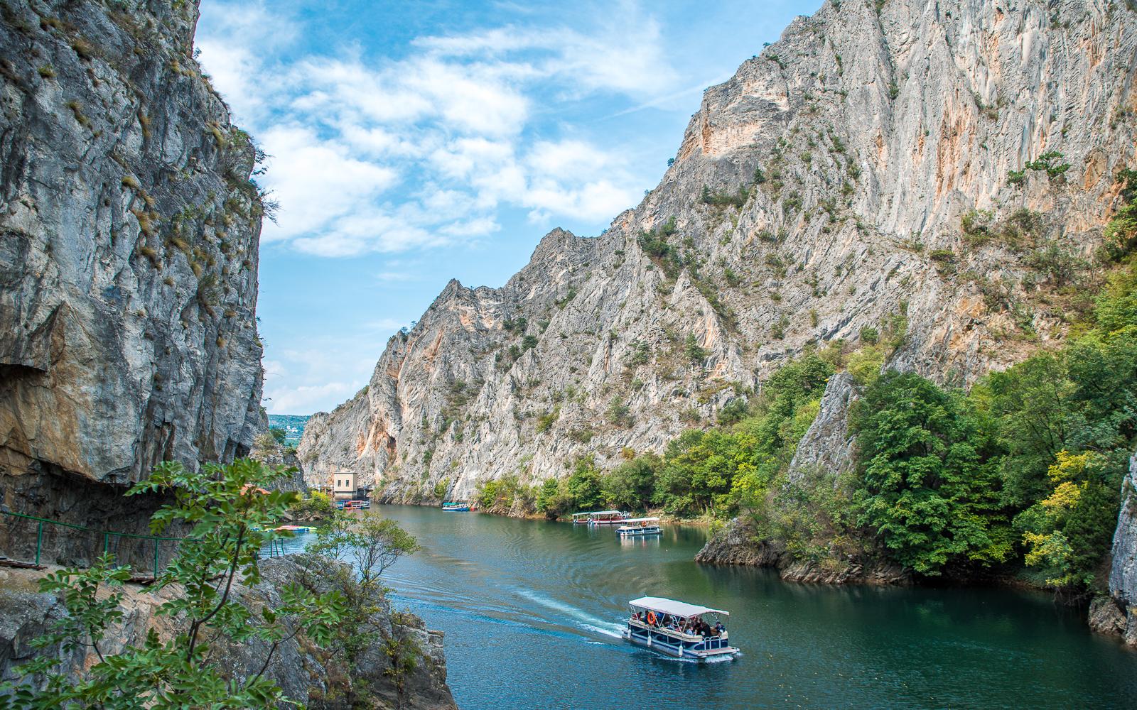 A boat crossing the emerald water of Matka Canyon